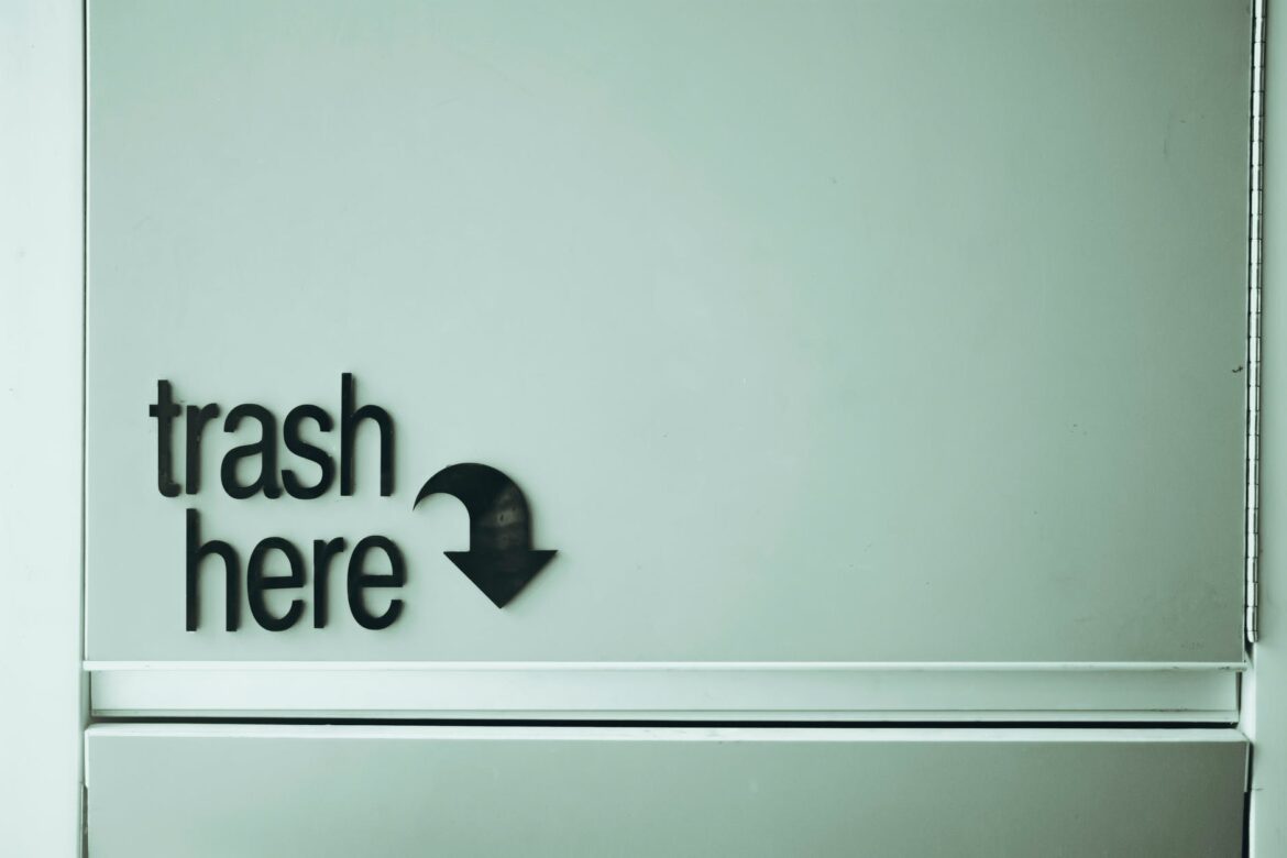 trash here inscription on door