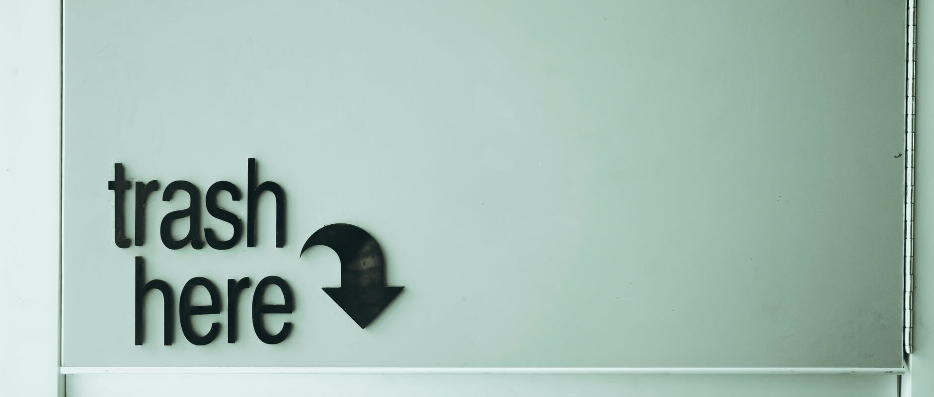 trash here inscription on door