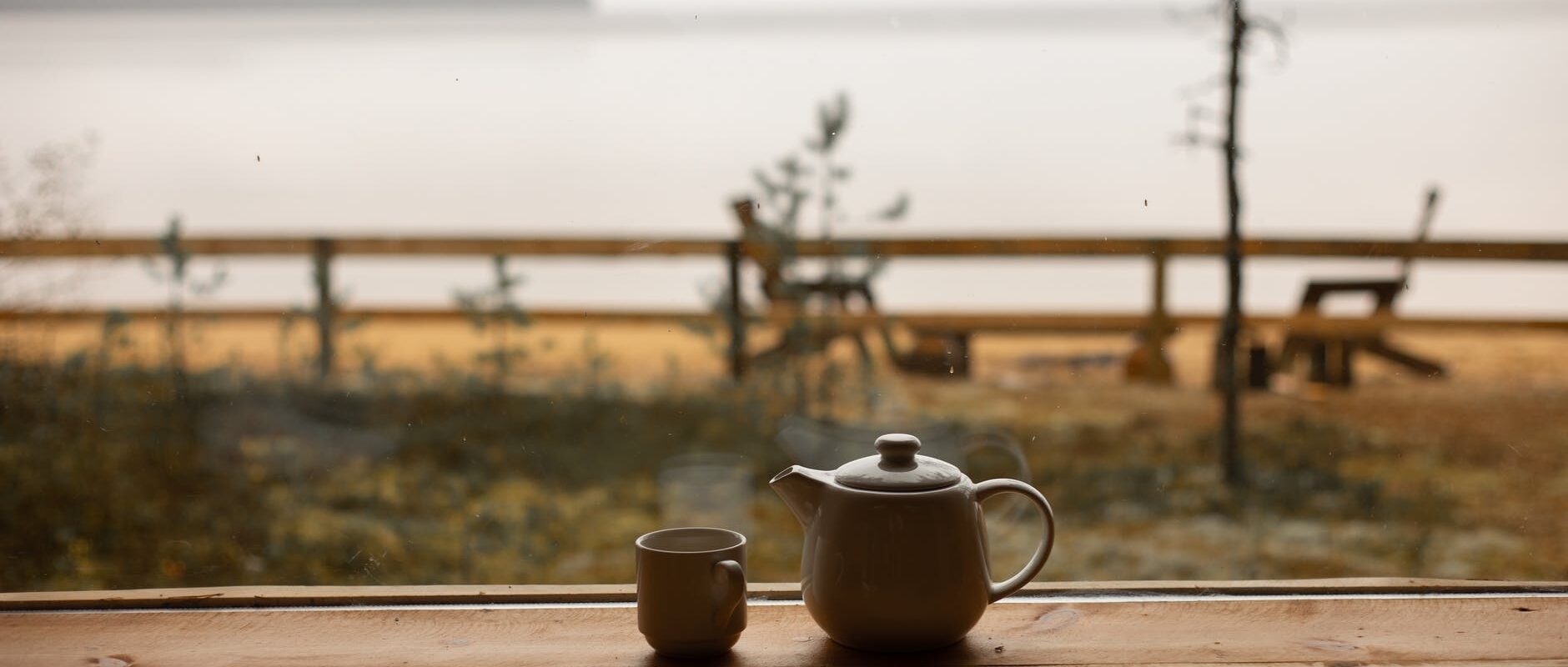 white ceramic tea kettle and a cup