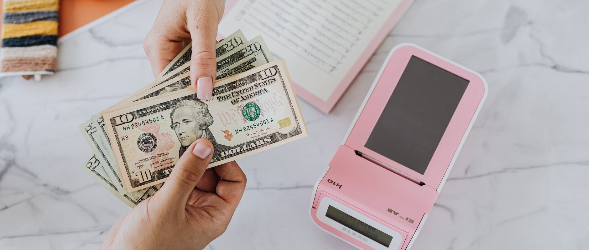hands holding dollars