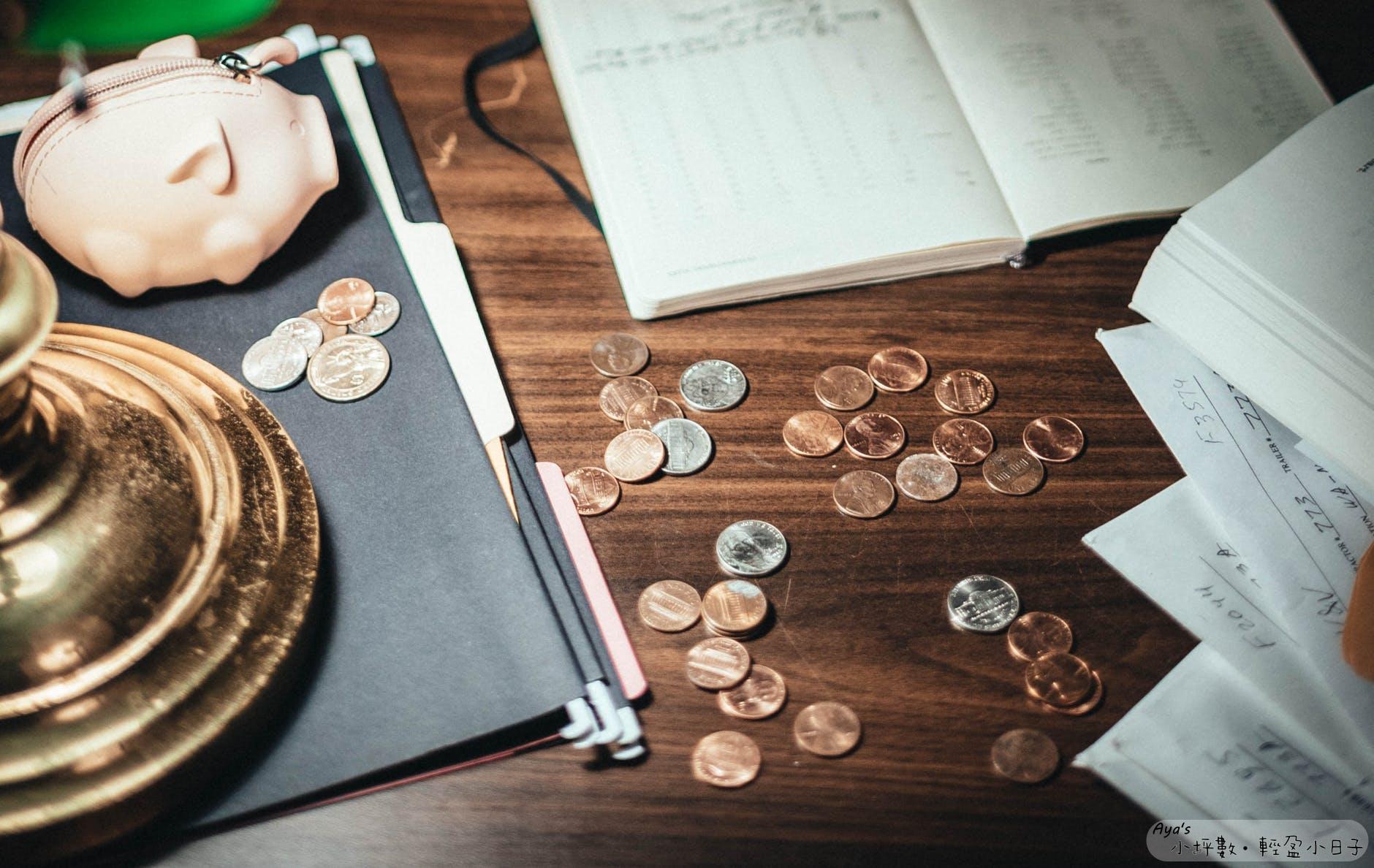 coins scattered on wooden surface