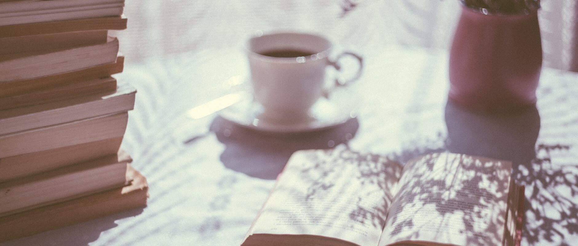 opened book near ceramic mug