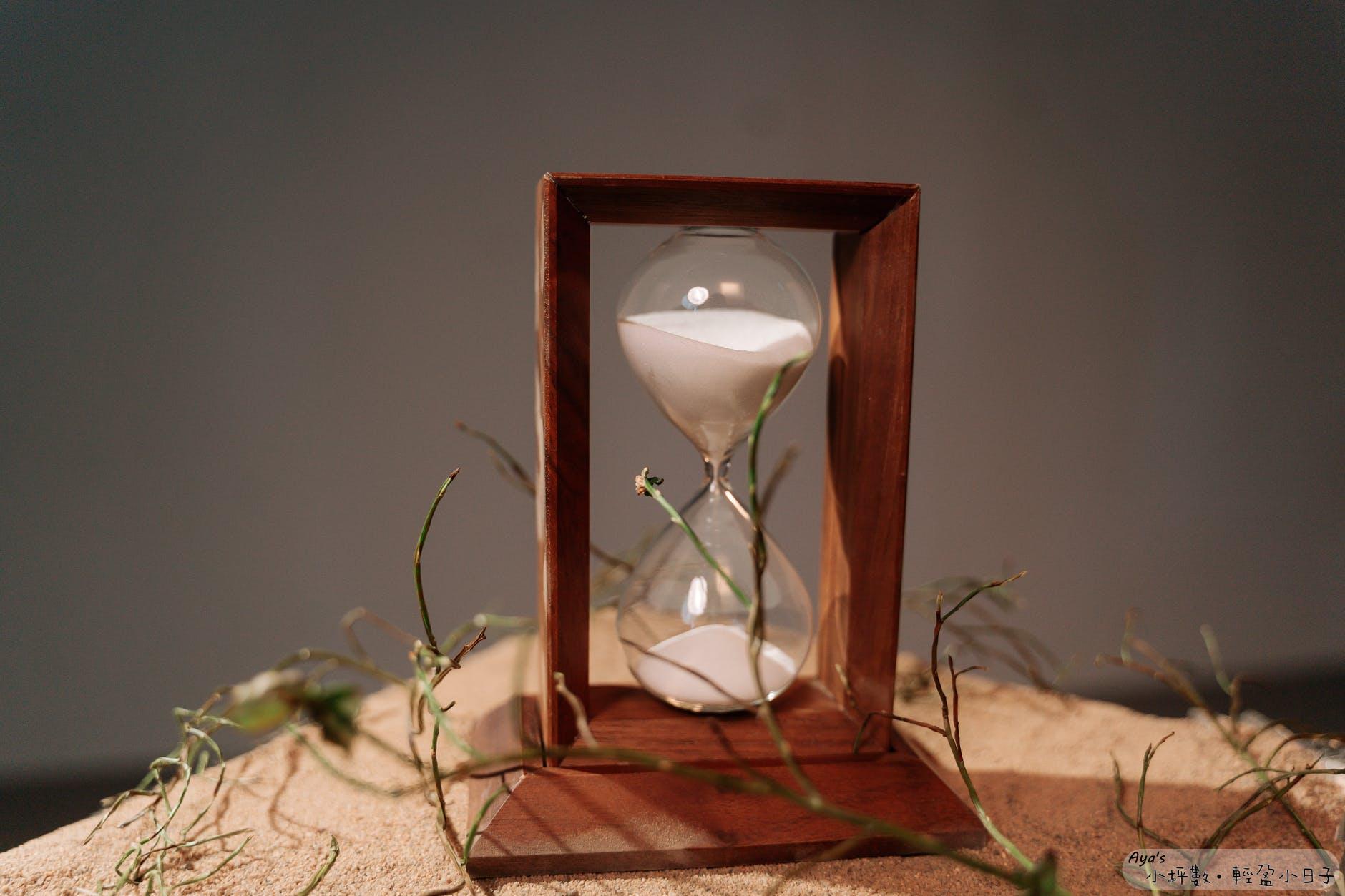 brown wooden framed hour glass